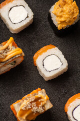 Sushi rolls in rows solid pattern on black background macro