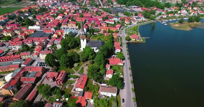 Aerial Backward Scenic Shot Of Church Amidst Houses On Sunny Day - Stockholm, Sweden