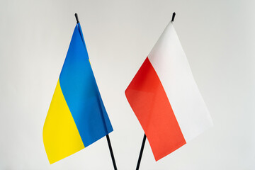 State flags of Ukraine and Poland on white background. Cooperation and help in war conflict concept