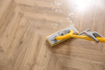 Washing of parquet floor with mop, above view. Space for text