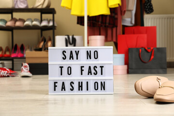 Lightbox with phrase SAY NO TO FAST FASHION on floor indoors