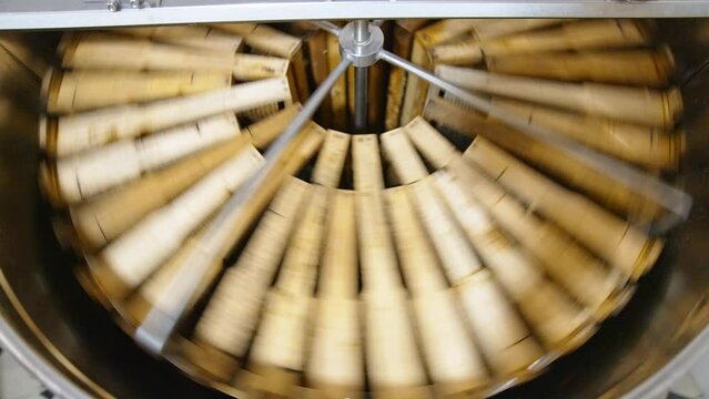 Working honey harvesting apparatus. Honey frames placed in circle are spinning in the centrifuge machine to extract healthy product.
