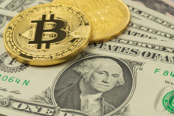 US Dollar banknotes and two Bitcoin coins