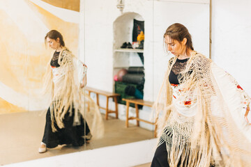 Flamenco female dancer training focused on a studio