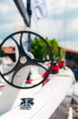Image of white sailboat starboard side with focus on pulley. Sailing, travel, vacation, tourism, transportation and nautical concepts.