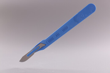 Scalpel, surgical stainless steel metal instrument on grey background