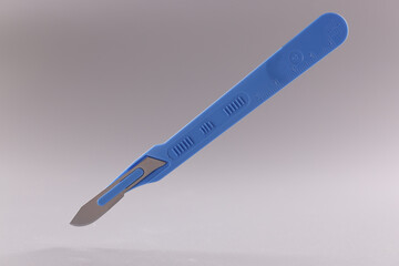 Scalpel, surgical stainless steel metal instrument on grey background