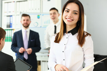 Fototapeta premium Smiling manager posing with colleagues in office, stylish look for work