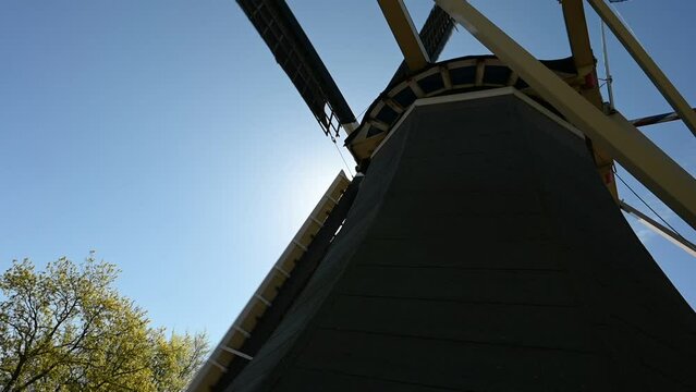 Traditional old rustic windmill at Netherlands. Dutch historical heritage. Tourism architecture landmark