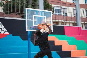 Young african man playing basketball outdoor - Focus on right hand