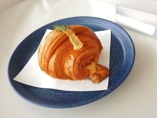 Crispy Ham Cheese Croissant on blue plate with utensils