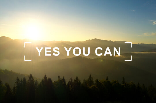 Yes You Can. Motivational quote inspiring to believe in yourself. Text against beautiful mountain landscape at sunrise