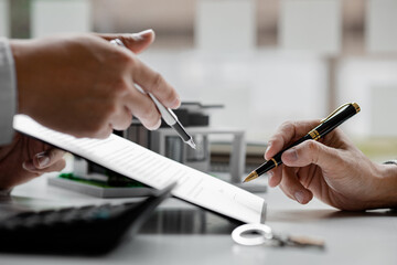 Rental company employee is discussing the details before the customer agrees to sign a rental...