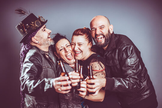 Friends Smile Together With Beer In Hand In Studio Shot