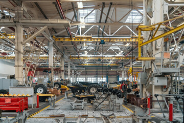 Big industrial factory. Manufacturing of agriculture machines. Workers and technique equipment in...