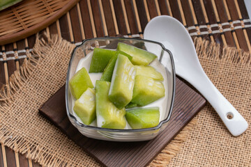 Summer dessert with Thai melon, fruit, and coconut milk.