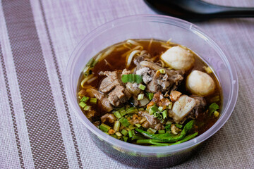 Braised pork and meatballs in a plastic cup.Delivery Food Box