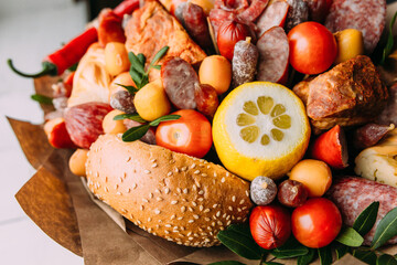 Delicious edible bouquet of sausage, tomatoes, cheese. Gift for man.