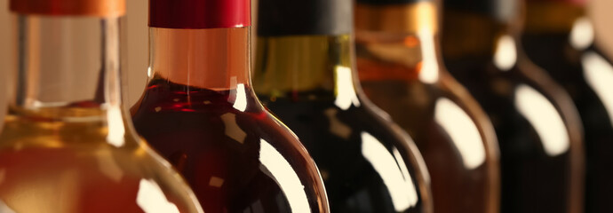 Bottles of different wines, closeup. Banner design