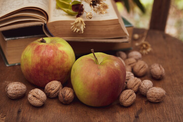 Naklejka na ściany i meble apples and books and walnuts in vintage colors