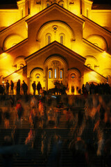 People traces in long exposure. View of Tsminda Sameba, Trinity Church for Easter night, Tbilisi, Georgia.