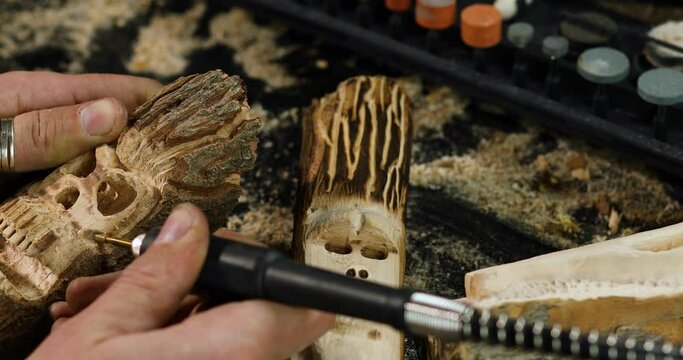 Close up male hands using power wood working tools graver, carving while crafting, Creating craft handmade souvenirs.
