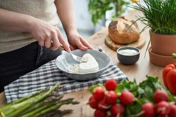 Woman making cottage cheese on spring season
