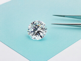 Loose Diamond on Tiffany Blue Coloured Background with Tweezers 