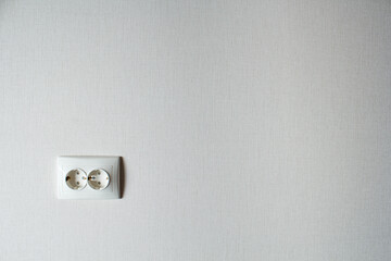 double electric socket on a light wall. Apartment renovation.