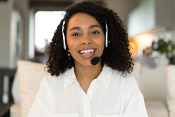Close up screen view headshot portrait of happy millennial african american woman in headphones talk on video call
