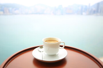 coffee with cup near the sea view of harbor in hong kong
