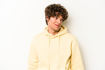 Young caucasian man isolated on white background shrugs shoulders and open eyes confused.