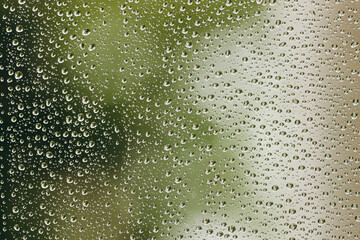 The relaxing raindrops is flowing down the window.