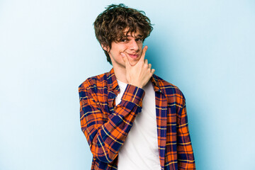 Young caucasian man isolated on blue background contemplating, planning a strategy, thinking about the way of a business.