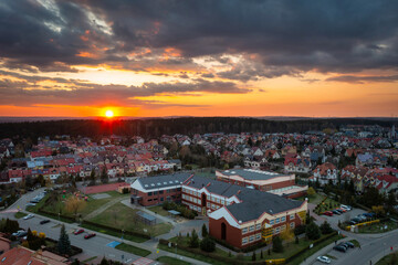 Fototapeta na wymiar Aerial landscape of the primary school in Rotmanka at sunset. Poland