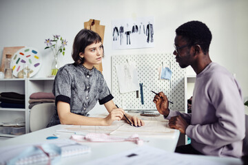 Team of young fashion designers working on collection of sewing patterns to sell online