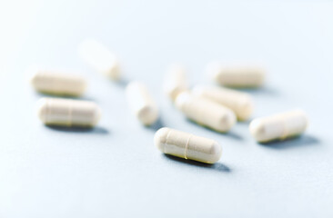Selenium capsules. Concept for a healthy dietary supplementation. Bright paper background. Soft focus. Close up. Copy space.