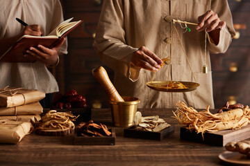 A moment of apocathery measuring ingredient in gold scale with chinese traditional medicine in...