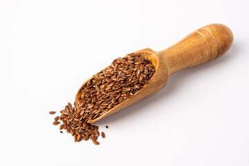 Wooden spoons with flaxseed on a white background