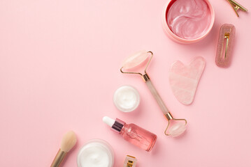 Beauty procedure concept. Top view photo of rose quartz roller gua sha makeup brushes pink eye...