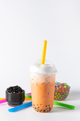 Traditional beverage of asia taiwan,  Ice buble or boba milk tea in plastic cup with straw on white background, summers refreshment.