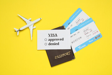 Flat lay composition with passport, toy plane and tickets on yellow background. Visa receiving