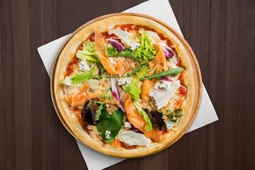 Traditional pizza with cheese and meat on wood desk. Pizza with four cheese combination. Cheese pizza.