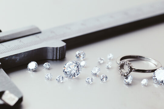 Workplace of a jeweler. Tools and equipment for jewelry work on an metal desktop. Jeweller at work on jewelry made of diamonds. Platinum Diamond Metal Background