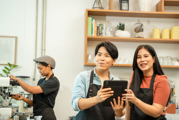 New business owner working on tablet at coffee shop,Small local business with organic hot drinks products.