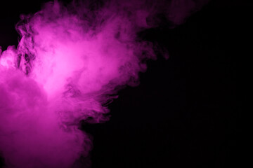 Obraz na płótnie Canvas Colorful smoke close-up on a black background. Blurred pink cloud of smoke.