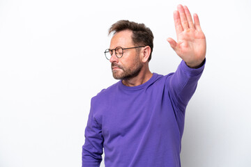 Middle age caucasian man isolated on white background making stop gesture and disappointed