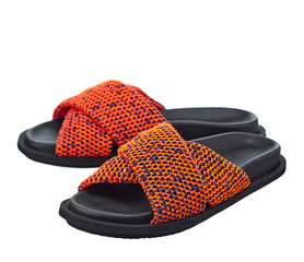 Beautiful pair of high-quality sandals with a bright orange brained top and a black leather sole, isolated on a white background. Comfortable shoes for beach holidays and summer walks.