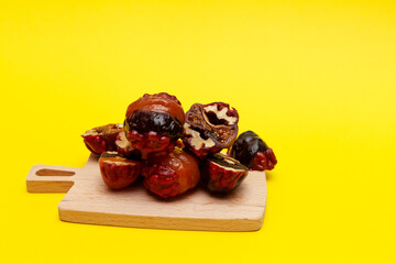 Candy sugar-free on yellow background. Healthy oriental sweets, selective focus. Energy bites made of dried fruits