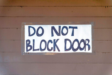 Do not block door signage on a brown wooden wall at San Francisco, California